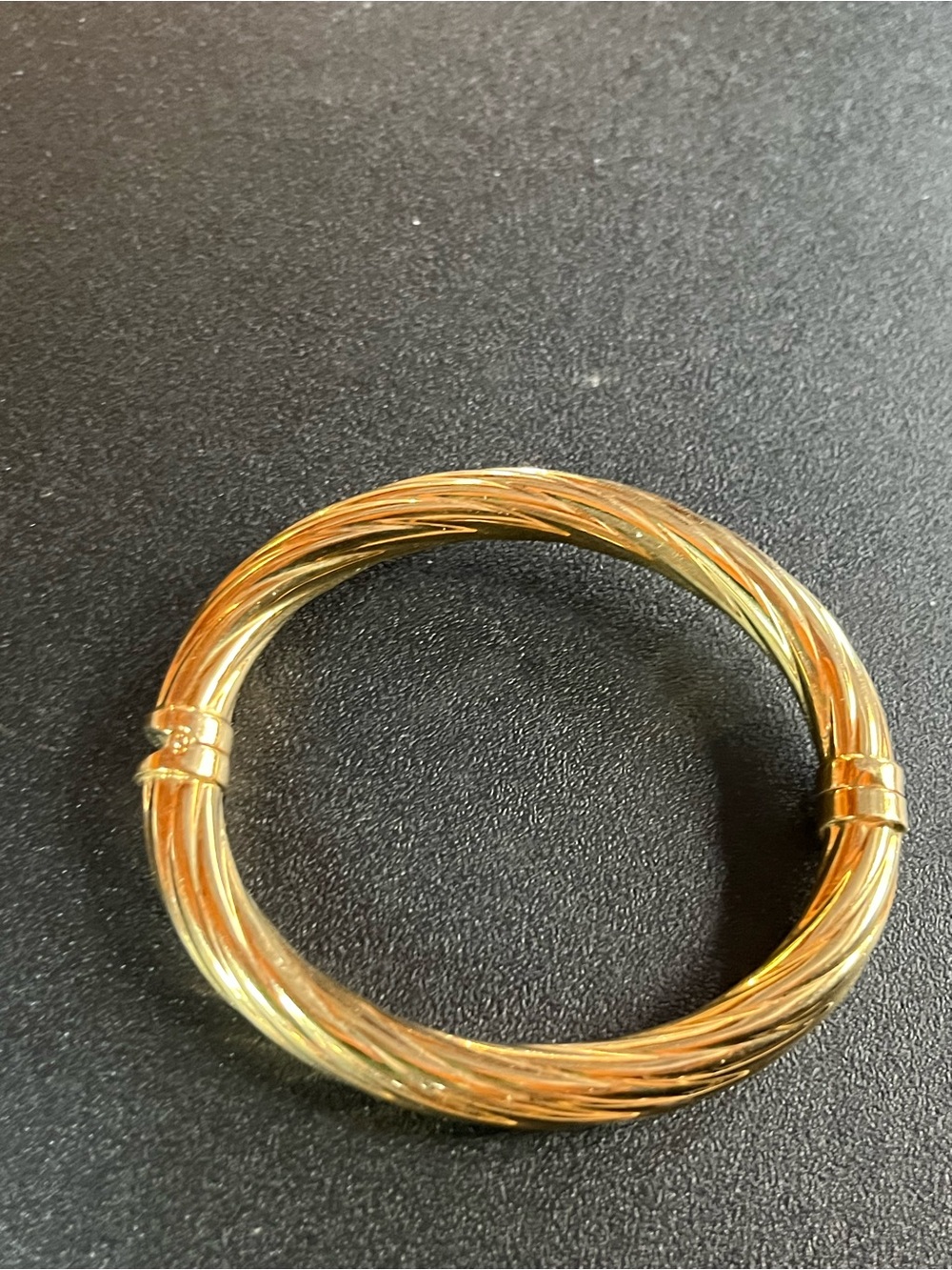 Sterling silver base. Gold-Tone Twisted Cable Bangle Bracelet. Spring hinge